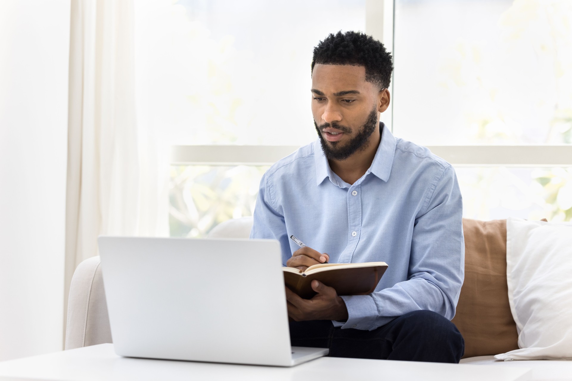 Serious African student man watching online lecture, training seminar